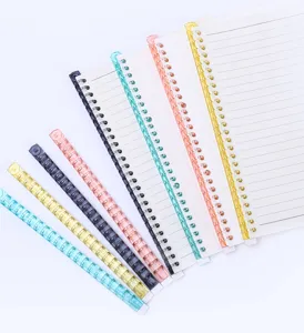 Detail view of colorful plastic loose leaf binder rings and notebooks for office stationery use.