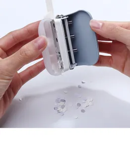 Mini 3-hole punch detail showing clear plastic compartment and metal mechanism for loose leaf paper.