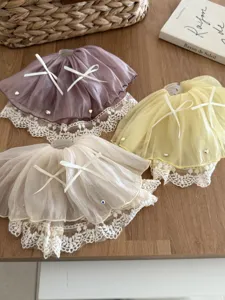 Detailed view of three French style bow lace skirt hair claw clips in various colors