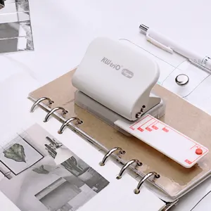 Mini adjustable 6-hole 9-hole paper puncher with positioning ruler for binder planner notebooks.