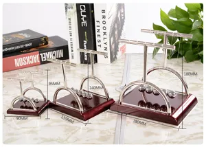Detailed display showing three sizes of Newton's cradle balance balls desktop physics toy.
