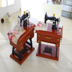 Vintage miniature sewing machine music box detail with retro design and classic mechanical parts.