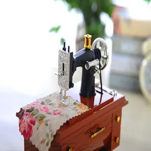 Miniature vintage sewing machine music box detail shot, perfect retro home decor gift.