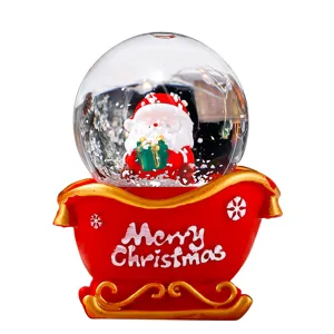 Weihnachten Weihnachtsmann Schneekugel mit rotem Schlitten als festliche Deko und Geschenk.