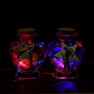 Creative heart-shaped glass wish bottle with iron tower pendant and colorful led lights.