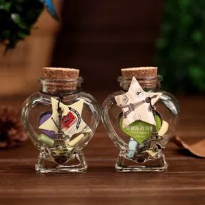 Heart shaped glass wishing bottles with cork stoppers, message notes and Eiffel Tower decor.