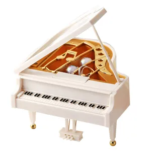 Mini piano jewelry box, elegant white and gold music box trinket organizer for home decor.