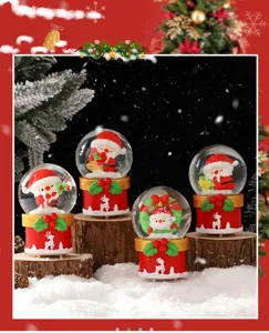 Close-up detail of glowing Christmas snow globe featuring cute Santa figures and festive bases.