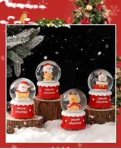 Christmas snow globe detail view, festive crystal ball with cute Santa and snowman figures.