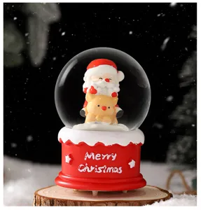 Christmas snow globe with Santa and reindeer figure, festive LED glowing desktop decoration gift.