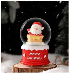 Detailed view of the cute Christmas Santa Claus snow globe with glowing light and festive base.