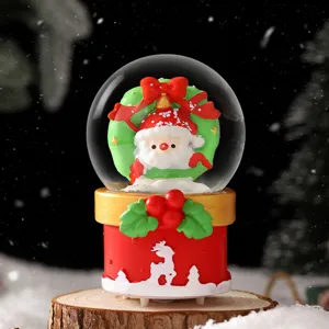 Christmas snow globe with glowing Santa Claus figurine, festive desktop decoration gift for holidays.
