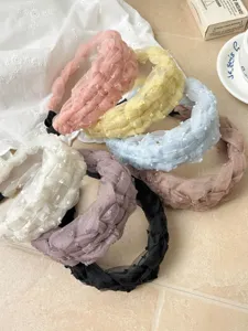Primer plano de diademas trenzadas de malla de colores con elegantes texturas de tela.