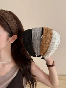 Close-up detail of stylish woven wide-brim headbands in multiple elegant colors