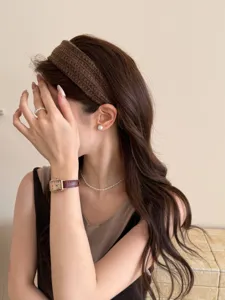Detailed view of a brown knitted wide headband styled for an elegant Korean look