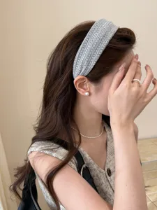 Close-up of a Korean style grey woven headband showing high-top hair aesthetic effect