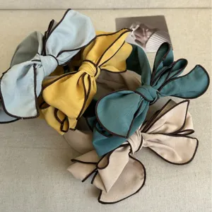 Elegant wide-brimmed bow headbands in multiple colors for a high-top stylish look.