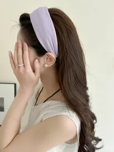 Side view of a creamy lilac knitted wide headband on a model for a Korean style look.