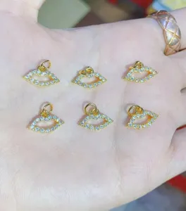 Gold plated micro pave cubic zirconia lip charm detail close-up for jewelry making.