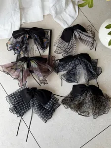 Detailed view showing various French mesh bow hair clips in polka dot and floral prints.