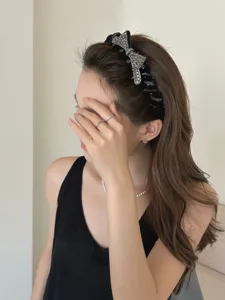 Sparkling rhinestone butterfly headband worn by a model, showing the elegant design detail.