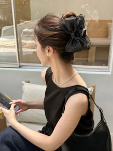 Elegant black organza bow hair claw clip for stylish bun updo hairstyles on Asian model