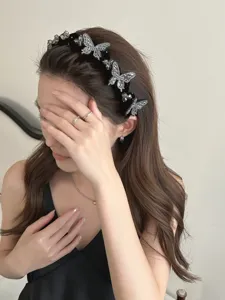 Close-up detail of luxury rhinestone butterfly headband on a model for elegant hair
