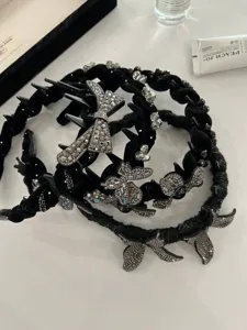 Macro view of luxurious black headbands decorated with shimmering rhinestones and butterflies.