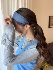 Side view of an Asian model wearing a minimalist blue fabric wide-brimmed headband.