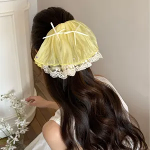 Elegant French style yellow lace bow hair claw clip for ponytail styling on long wavy hair