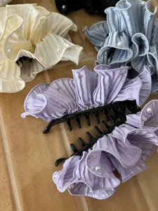 Elegant ruffled satin banana hair clips with pearl accents in multiple pastel colors