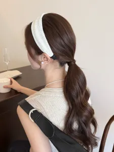 Close-up detail view of a minimalist white knitted wide headband for high top hair style