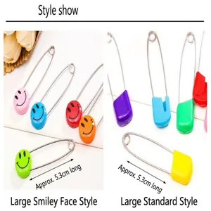 Colorful safety pins detail view, large smiley face and regular bread head baby pins 5.3cm.