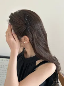 Detail view of a black polka dot bow hair comb styled for a Korean princess look.