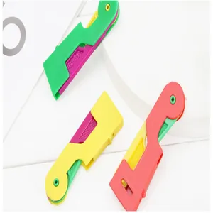 Detail shot of colorful automatic needle threaders, compact and portable sewing tool.