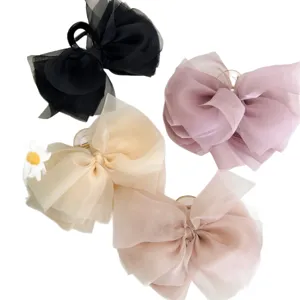 Set extra grote haarklemmen met organza strik in elegante pastelkleuren en zwart.