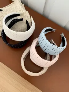 Close-up of colorful polka dot padded headbands in assorted pastel colors for women
