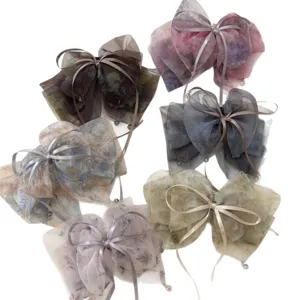 Elegant fairy-style mesh bow hair clips with soft watercolor floral ink-dye prints