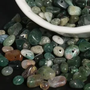 Close-up details of irregular drilled crystal gemstone chips for DIY jewelry making supplies.