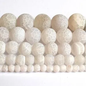 Close-up detail of white crackled agate round beads for DIY jewelry making and bracelets.