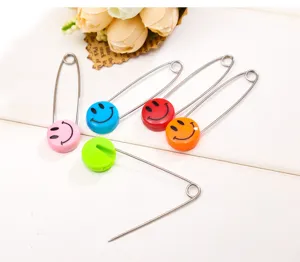 Colorful smiley face safety pins, large diaper pins for baby, durable metal pins detail view.