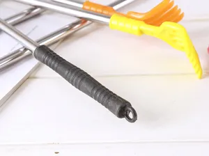 Close-up detail of the extendable back scratcher with a comfortable handle and durable metal.