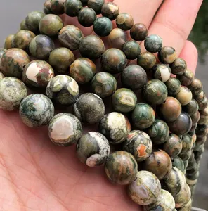 Close-up detail of natural patterned stone round beads, semi-finished DIY handmade jewelry crafting.