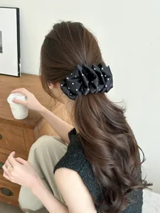 Elegant black polka dot cloud bubble banana hair clip accessory shown on model