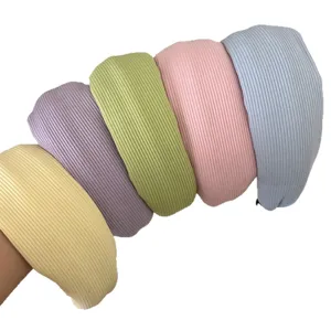 Collection of five colorful pastel knitted wide-edged headbands in soft cream tones