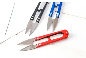 U-shaped thread scissors detail shot, stainless steel blade with spring handle for sewing and crafts.