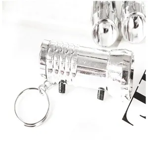 Portable mini LED flashlight keychain with metal ring, compact outdoor emergency light tool.