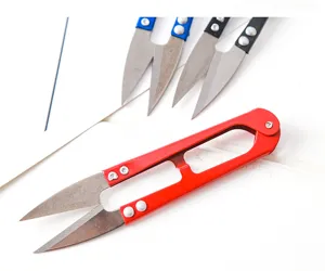 Close-up detail shot of U-shaped yarn scissors and thread clippers, sharp metal spring blade.