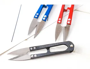 Closeup detail of U-shaped thread scissors with sharp metal blades and spring handles.