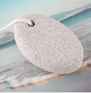 Detail view of oval white pumice stone with hanging cord, perfect for exfoliating foot skin.